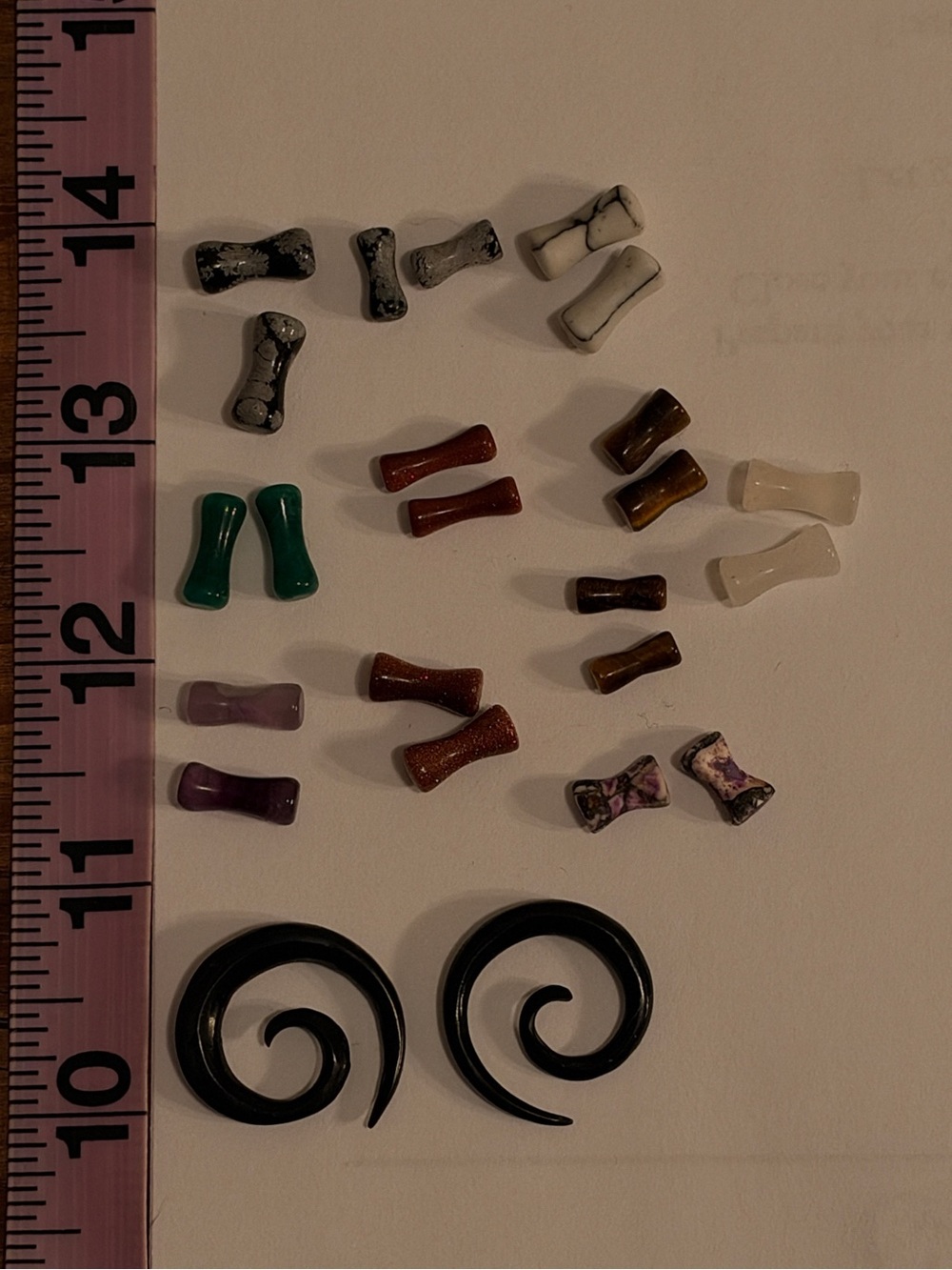 Array of gauged ear stone plugs 6g 8g 4g horn spiral